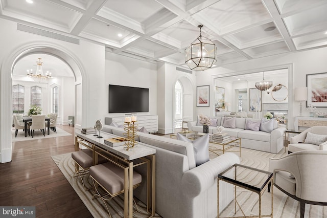 living room with beam ceiling, wood-type flooring, and coffered ceiling