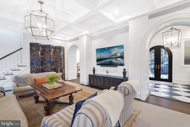 4825 Dexter Ter NW, Washington, DC 20007 - living area featuring arched walkways, a chandelier, french doors, wood-type flooring, and beam ceiling