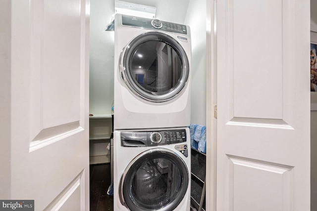 laundry area with stacked washer / drying machine