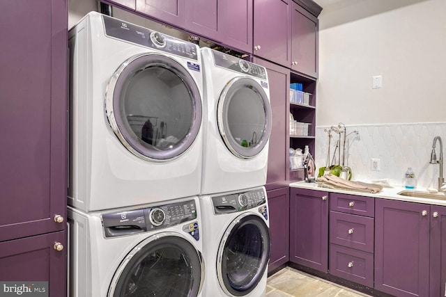 washroom with stacked washer / drying machine, cabinets, independent washer and dryer, and sink