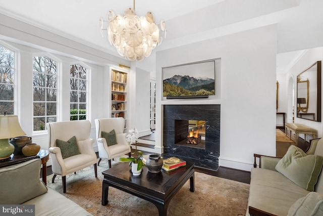 4825 Dexter Ter NW, Washington, DC 20007 - living room with a high end fireplace, a chandelier, healthy amount of natural light, built in features, and ornamental molding