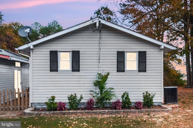 property exterior at dusk featuring central AC