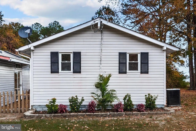 view of side of property featuring central AC