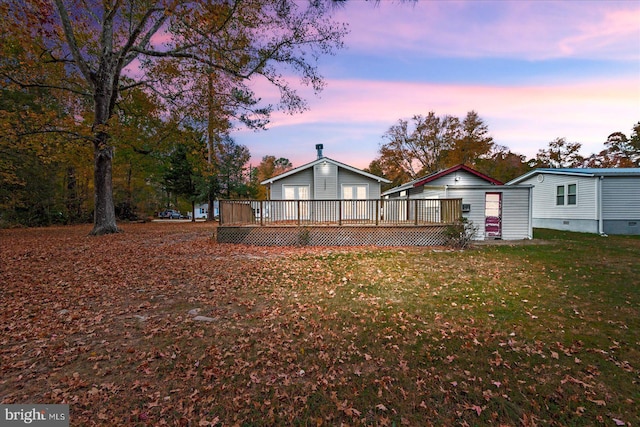 view of front of house featuring a yard and a deck