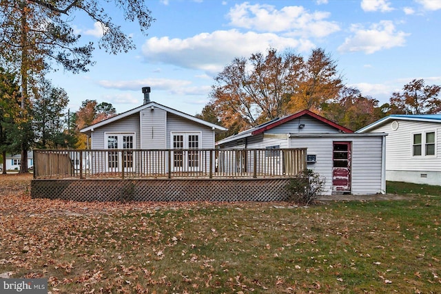 back of house featuring a yard and a wooden deck