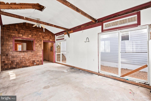 interior space featuring vaulted ceiling with beams and ceiling fan