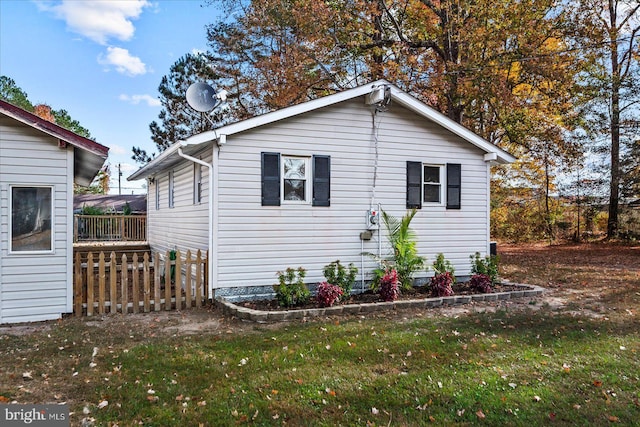 view of home's exterior featuring a yard and a deck