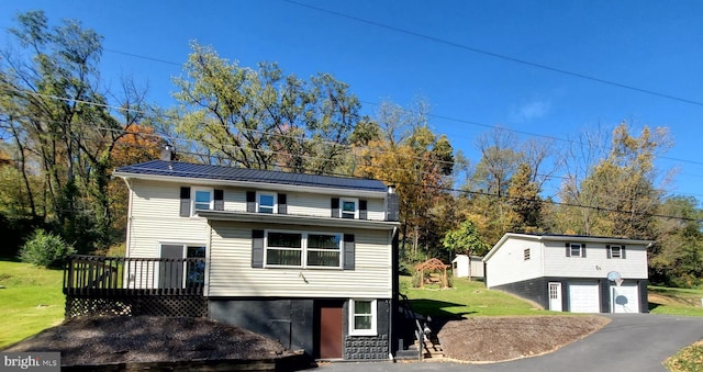 view of property featuring a garage and a deck