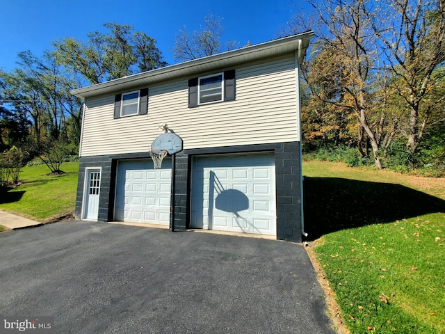 garage featuring a lawn