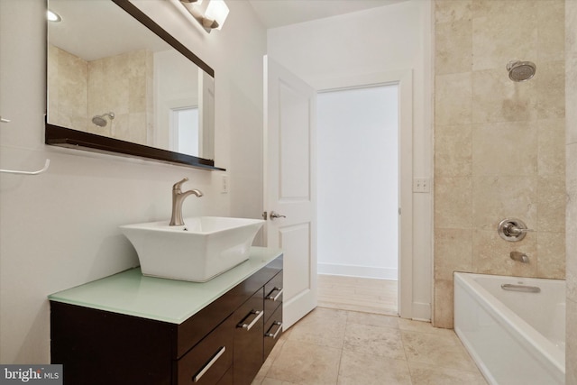 bathroom featuring tiled shower / bath combo, vanity, and tile patterned flooring