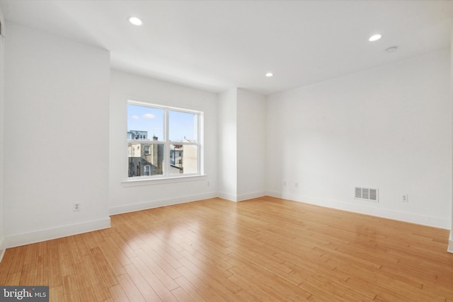 spare room with light hardwood / wood-style flooring