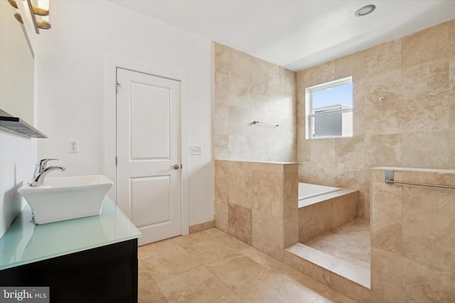 bathroom featuring vanity, tile walls, and tile patterned flooring