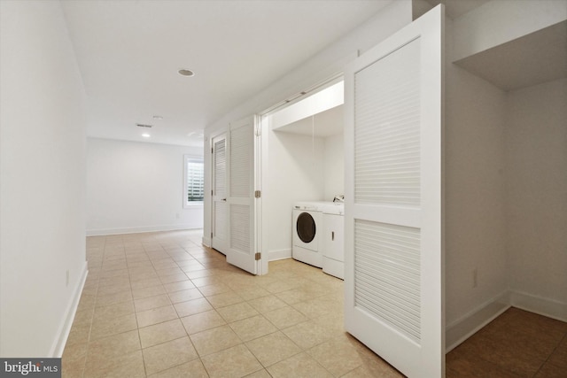 clothes washing area with light tile patterned floors and independent washer and dryer