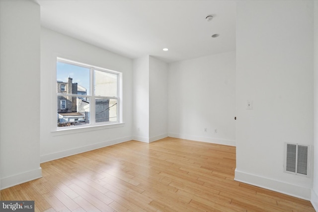 spare room featuring light hardwood / wood-style flooring