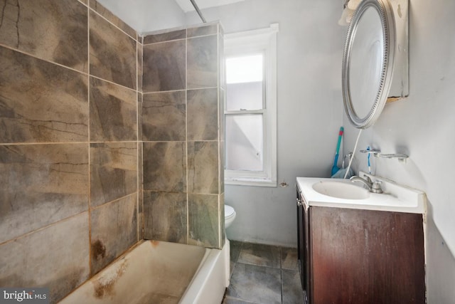 full bathroom with vanity, tile patterned floors, toilet, and tiled shower / bath