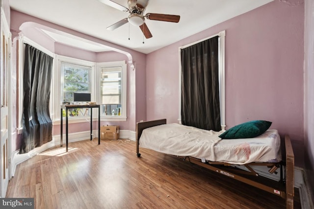 bedroom with wood-type flooring and ceiling fan