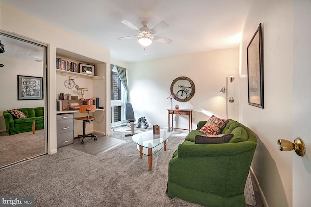 living room featuring ceiling fan and carpet flooring