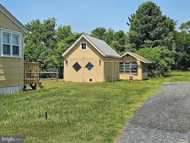 view of outbuilding featuring a yard