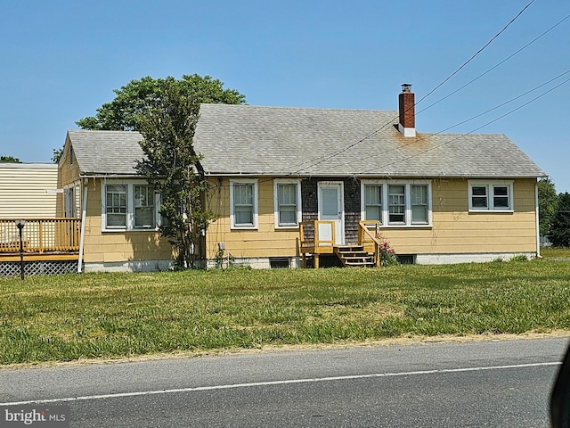 view of front of property featuring a deck and a front lawn