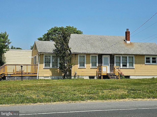 view of front of house featuring a deck and a front lawn