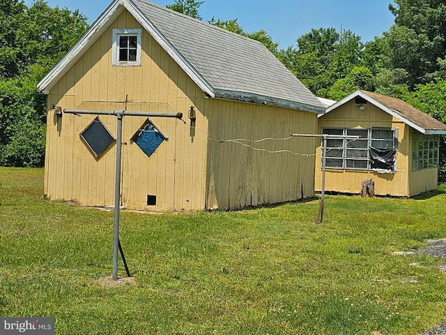 view of outdoor structure featuring a lawn