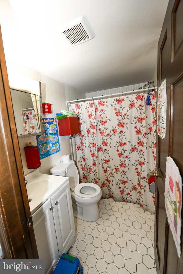 bathroom featuring toilet and vanity