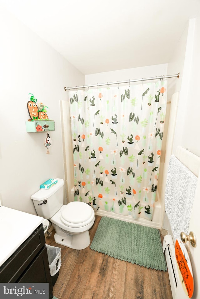 full bathroom featuring vanity, hardwood / wood-style flooring, a baseboard heating unit, toilet, and shower / bath combo with shower curtain