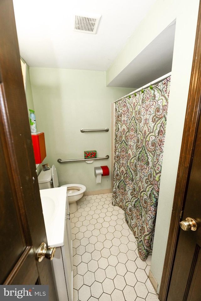 bathroom featuring vanity and toilet