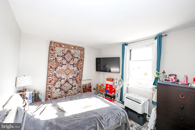 bedroom featuring an AC wall unit