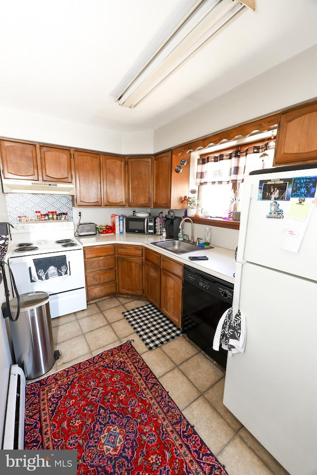 kitchen featuring a baseboard heating unit, tasteful backsplash, sink, and white appliances