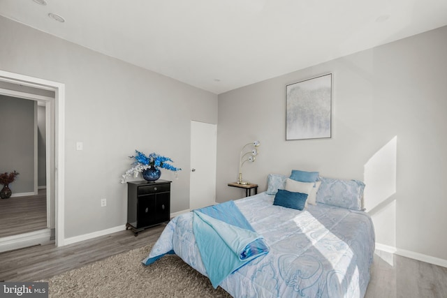 bedroom with hardwood / wood-style flooring