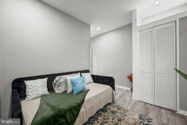 bedroom with light wood-type flooring and a closet