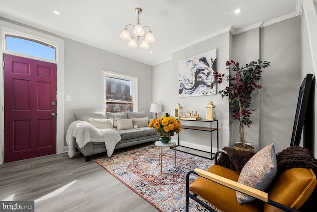 living room featuring a chandelier, hardwood / wood-style flooring, and ornamental molding