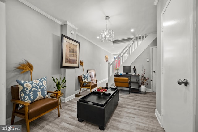 living area with a chandelier, hardwood / wood-style flooring, and crown molding