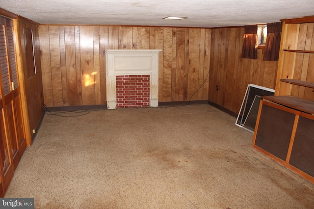 basement featuring light colored carpet, wood walls, and a textured ceiling