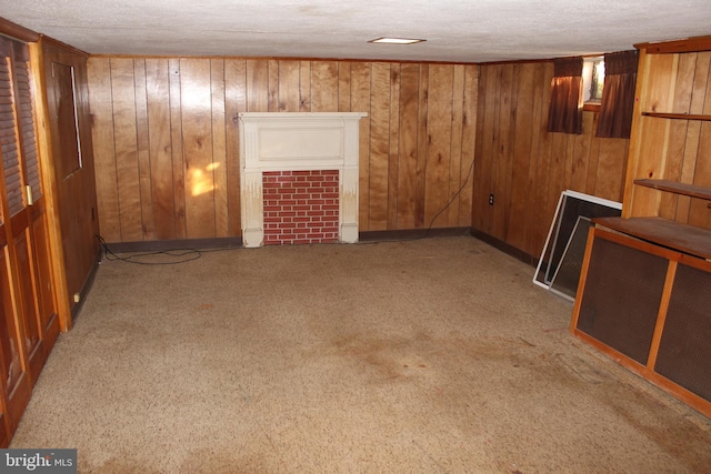 61 S Carl Ave, Greencastle, PA 17225 - carpeted spare room featuring wood walls, a textured ceiling, and a tiled fireplace