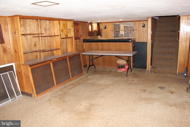 basement with wood walls and carpet flooring