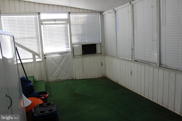 unfurnished sunroom with cooling unit and vaulted ceiling