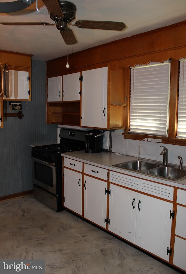 61 S Carl Ave, Greencastle, PA 17225 - kitchen with gas stove, a sink, white cabinets, ceiling fan, and light countertops