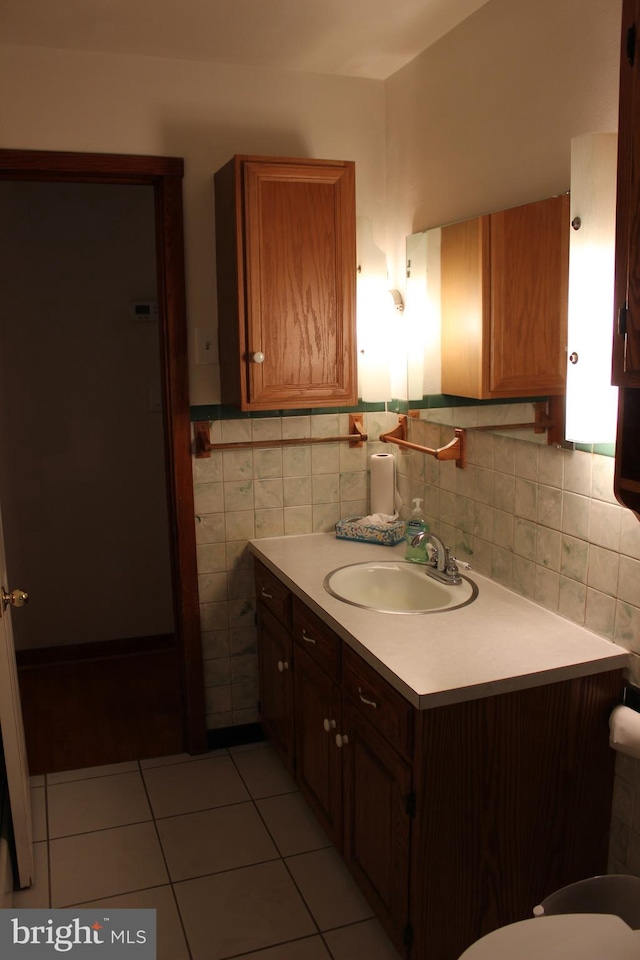 bathroom with vanity, tasteful backsplash, and tile patterned floors