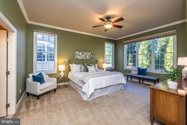 bedroom with ceiling fan, crown molding, and light colored carpet