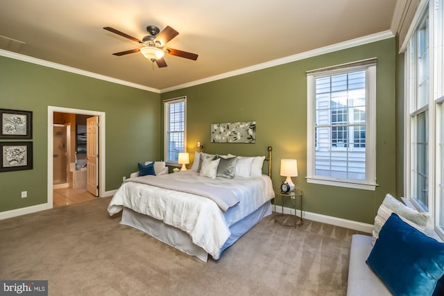 carpeted bedroom featuring ensuite bath, ceiling fan, and crown molding