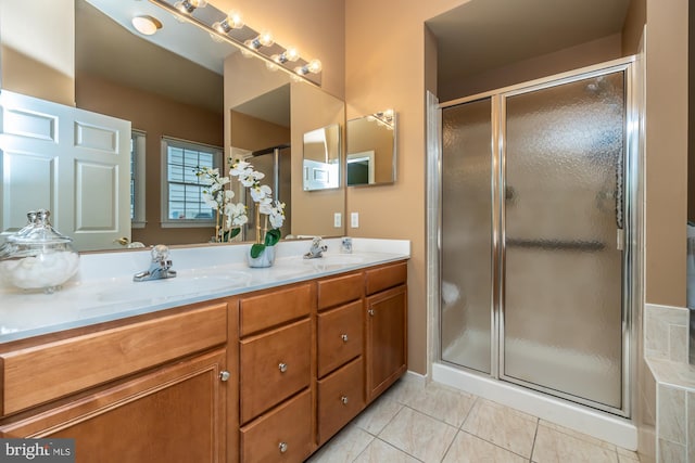 bathroom featuring tile patterned flooring, vanity, and an enclosed shower