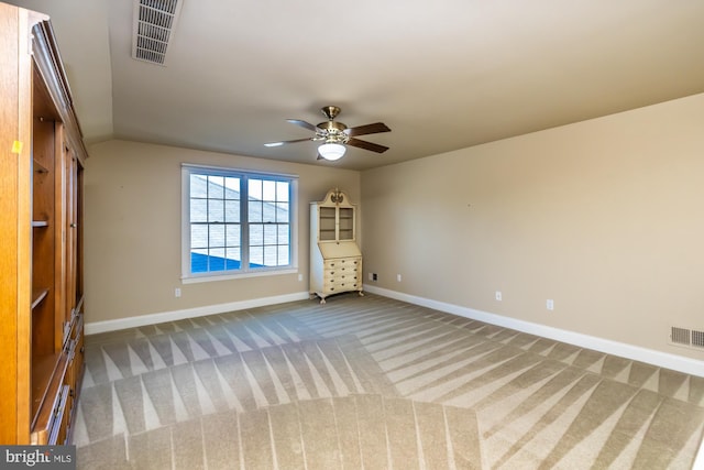 unfurnished bedroom with ceiling fan, vaulted ceiling, carpet floors, and a closet