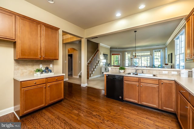 kitchen with sink, hanging light fixtures, black dishwasher, dark hardwood / wood-style floors, and ornamental molding