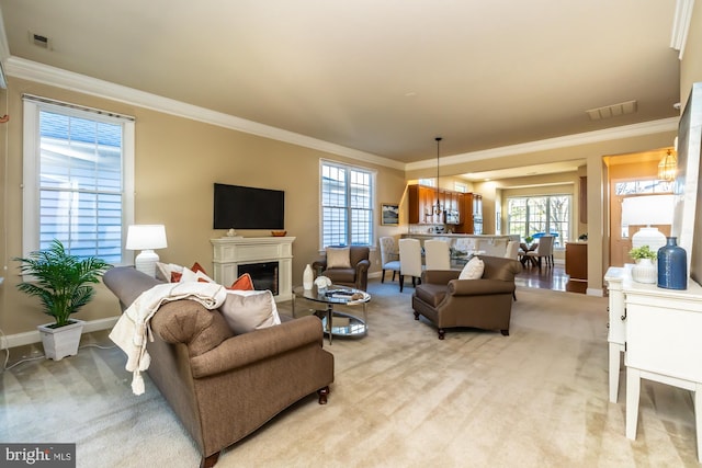 living room featuring light carpet, a notable chandelier, and ornamental molding