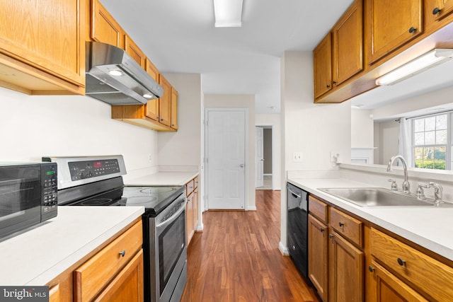 kitchen with sink, black appliances, and dark hardwood / wood-style flooring