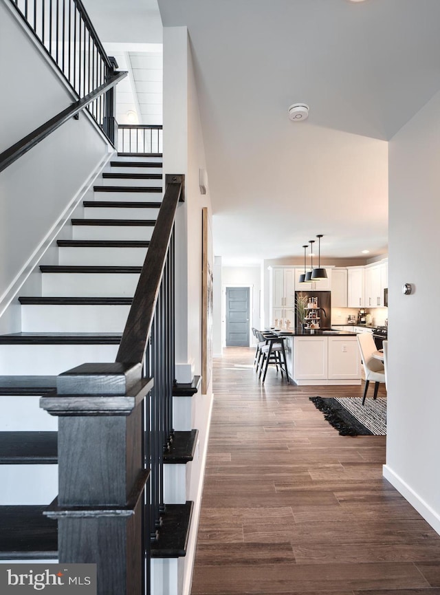 stairs with hardwood / wood-style flooring