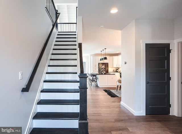 staircase with wood-type flooring