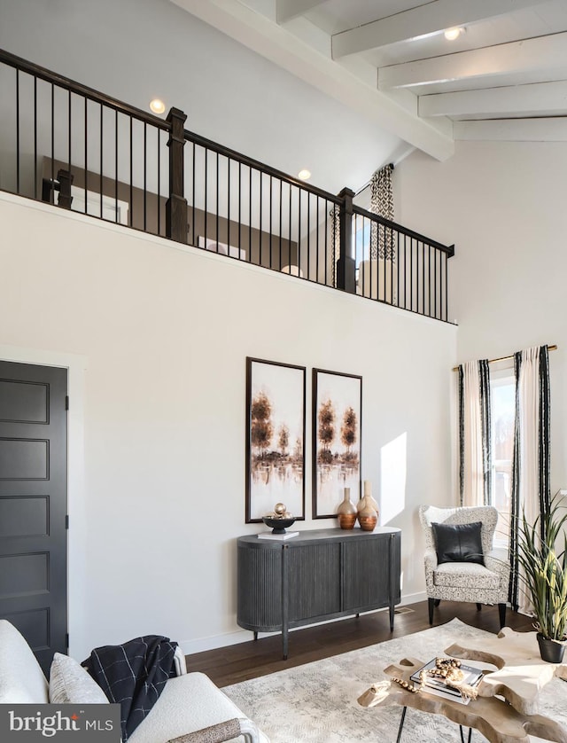 living room with hardwood / wood-style floors, beamed ceiling, and high vaulted ceiling